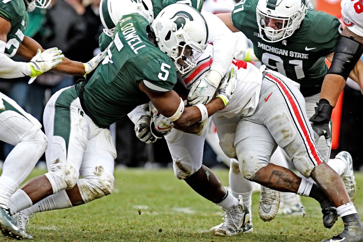 Michigan State's Andrew Dowell, left, tackles Ohio State's Mike Weber Jr. during the fourth quarter on Saturday, Nov. 10, 2018, in East Lansing. 2018 Msu Football 032 © Nick King/Lansing State Journal