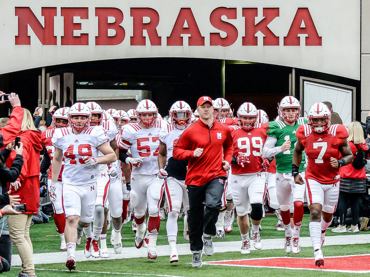 Nebraska football and coach Scott Frost run out of the tunnel