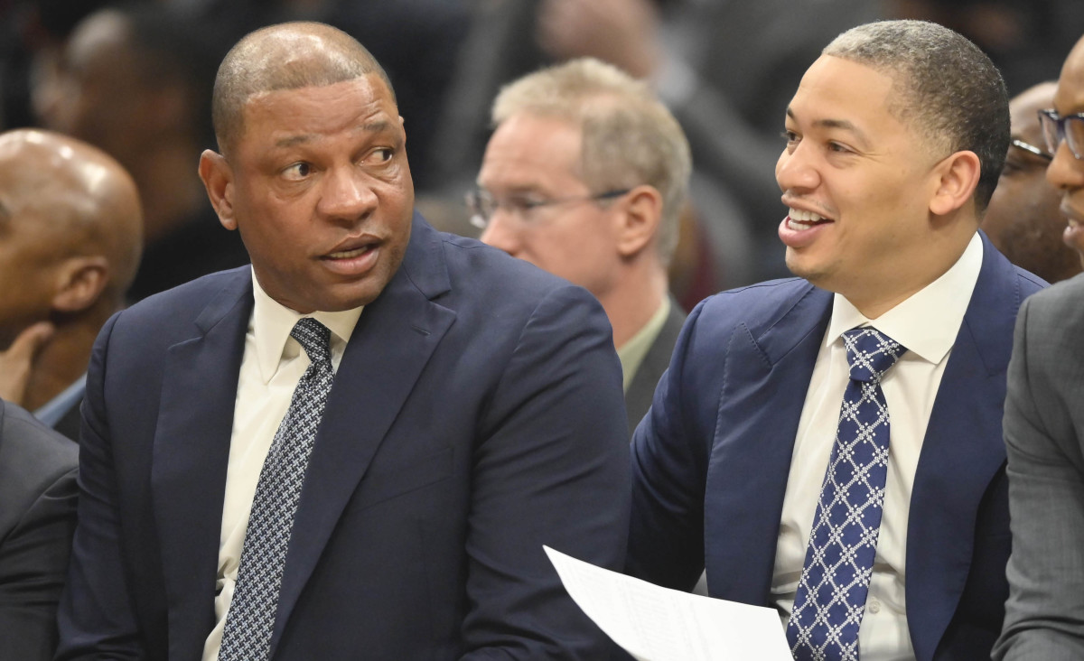 LA Clippers head coach Doc Rivers, left, talks with assistants Tyronn Lue,