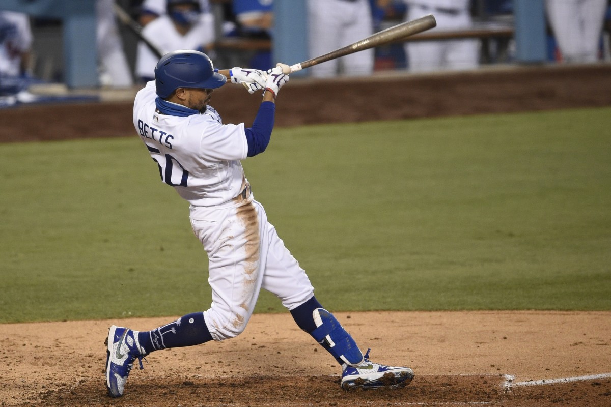 Aug 13, 2020; Los Angeles, California, USA; Los Angeles Dodgers right fielder Mookie Betts (50) hits a solo home run during the fourth inning against the San Diego Padres at Dodger Stadium. Mandatory Credit: Kelvin Kuo-USA TODAY Sports