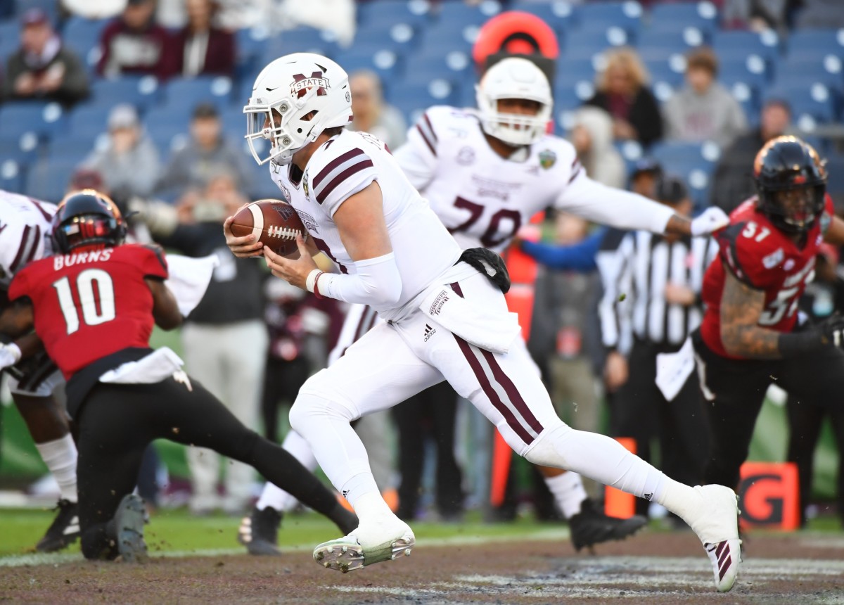 Dec 30, 2019; Nashville, Tennessee, USA; Mississippi State Bulldogs quarterback Tommy Stevens (7) runs out of his own end zone during the first half against the Louisville Cardinals at Nissan Stadium. Mandatory Credit: Christopher Hanewinckel-USA TODAY Sports