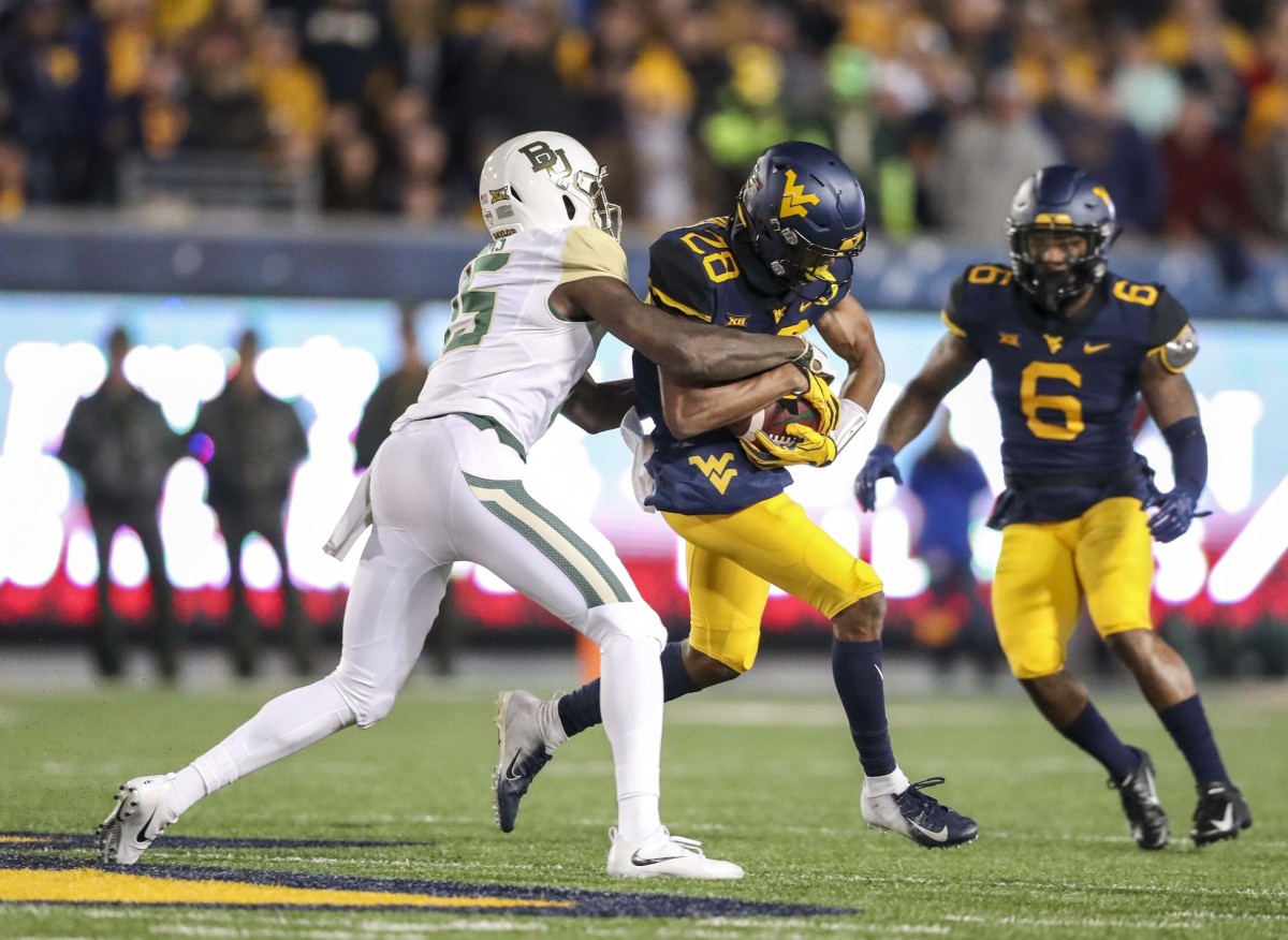 Oct 25, 2018; Morgantown, WV, USA; West Virginia Mountaineers cornerback Keith Washington (28) intercepts a pass during the first quarter against the Baylor Bears at Mountaineer Field at Milan Puskar Stadium. Mandatory Credit: Ben Queen-USA TODAY