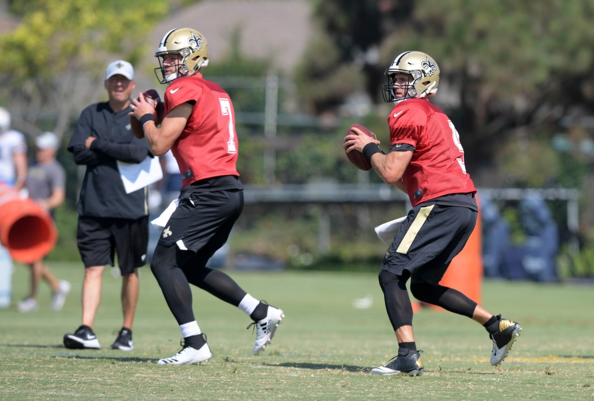 Aug 23, 2018; Costa Mesa, CA, USA: New Orleans Saints quarterback Taysom Hill (7) and quarterback Drew Brees (9) throw the ball as offensive coordinator Pete Carmichael (left) watches during joint practice against the Los Angeles Chargerat the Jack. R. Hammett Sports Complex. Mandatory Credit: Kirby Lee-USA TODAY Sports