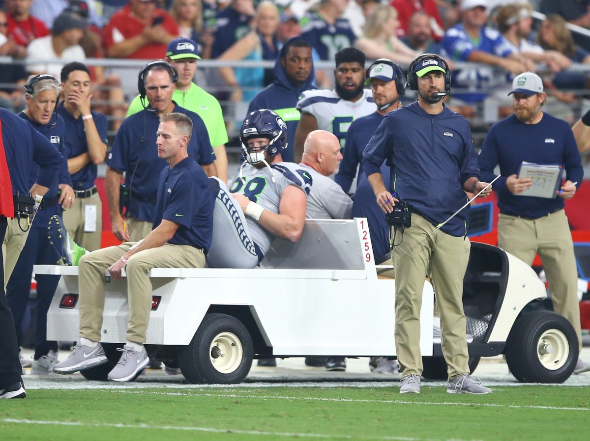 Will Dissly leaves the field in Arizona with an injury.