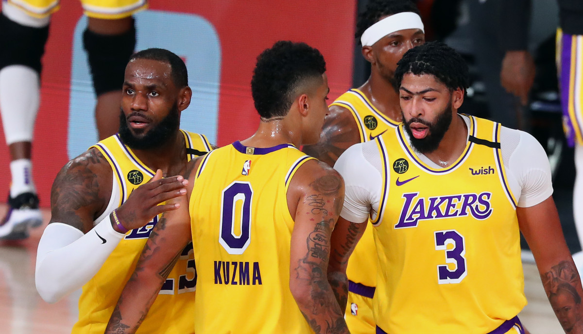 Los Angeles Lakers forward LeBron James (23) controls the ball against Portland Trail Blazers guard Gary Trent Jr. (left) during the first half of a NBA basketball first round playoff game
