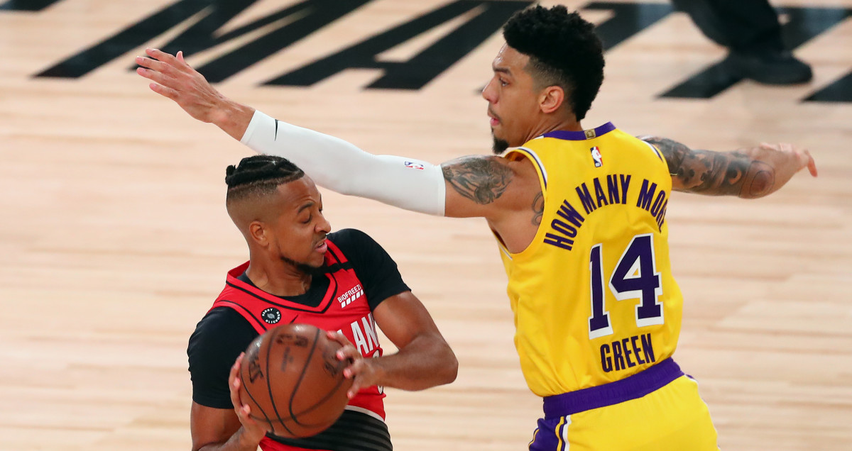 Portland Trail Blazers guard CJ McCollum (3) controls the ball against Los Angeles Lakers guard Danny Green (14) during the first half of a NBA basketball first round playoff gam