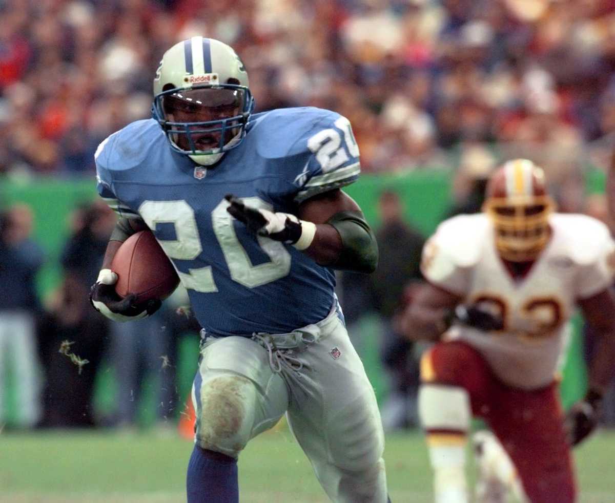 Barry Sanders carries the ball during a game against the Washington Football Team. He is the most prolific running back in franchise history with 15,269 rushing yards.