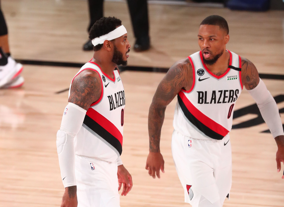 Portland Trail Blazers guard Damian Lillard (0) and forward Carmelo Anthony (00) talk in the second half against Los Angeles Lakers in game three of the first round of the 2020 NBA Playoffs