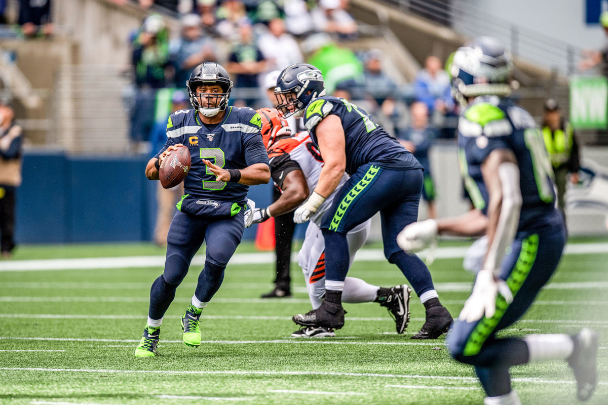Russell Wilson escapes pressure and looks for DK Metcalf downfield