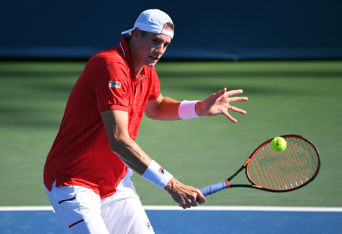 John Isner (USA) hits the ball against Hubert Hurkacz (POL) during the Western & Southern Open at the USTA Billie Jean King National Tennis Center.