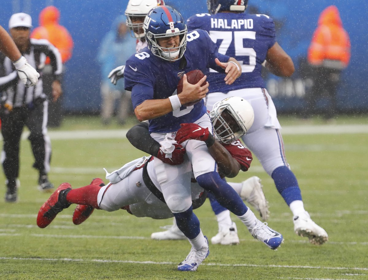 Giants quarterback Daniel Jones (8) is tackled by Cardinals linebacker Chandler Jones (55) during the second half of a 2019 game at MetLife Stadium.