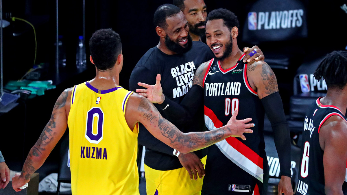 Carmelo Anthony chats with LeBron James and Kyle Kuzma after NBA playoff game
