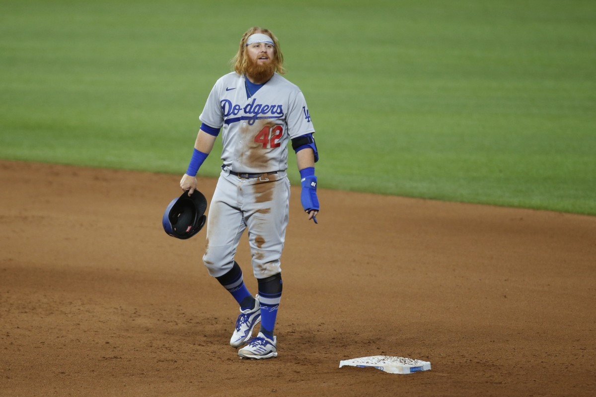 Aug 28, 2020; Arlington, Texas, USA; Los Angeles Dodgers third baseman Justin Turner reacts after suffering an injury sliding in to second base in the seventh inning against the Texas Rangers at Globe Life Field. Mandatory Credit: Tim Heitman-USA TODAY Sports