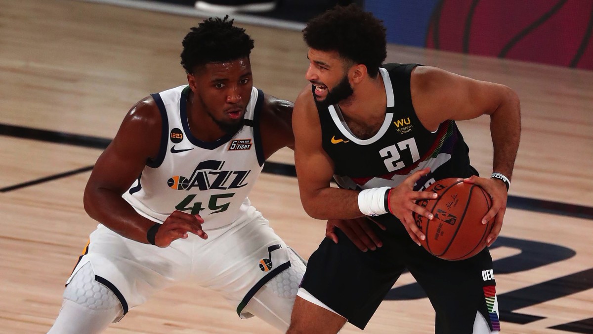 Denver Nuggets guard Jamal Murray (27) controls the ball against Utah Jazz guard Donovan Mitchell (45) during the second half of game seven of the first round of the 2020 NBA Playoffs at ESPN Wide Wor...