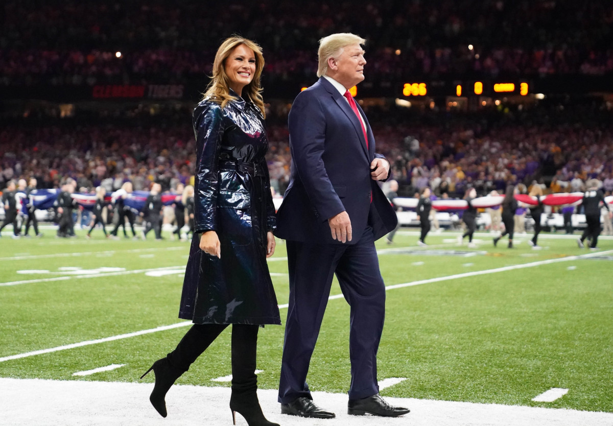 President Donald J. Trump and First Lady Melania Trump walk off the field before the College Football Playoff national championship game between the Clemson Tigers and the LSU Tigers at Mercedes-Benz Superdome.