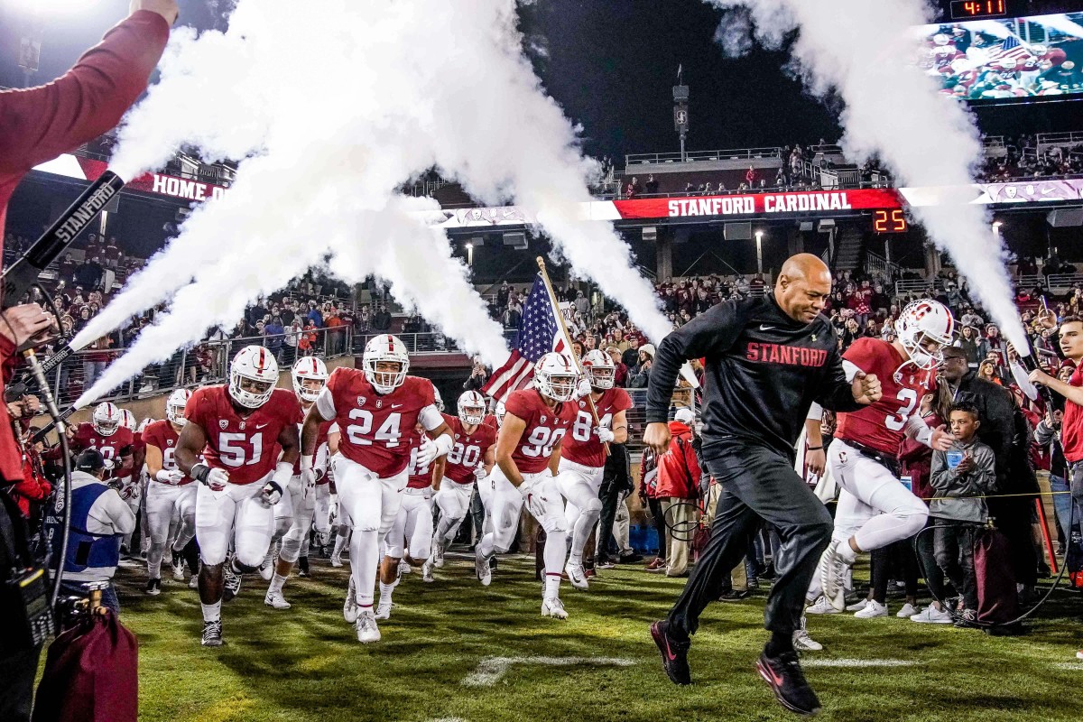 Stanford coach David Shaw runs out with his team