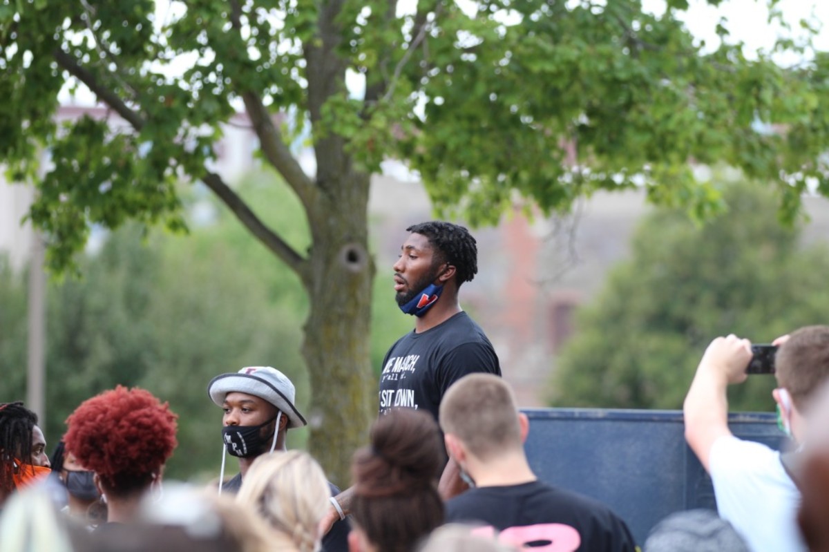Illinois defensive back Nate Hobbs speaking to the protest participants outside the Champaign city police building. Hobbs was among several Illinois players organizing a one-mile march from to the Grange Grove tailgating area just outside Memorial Stadium to the Champaign police department. 