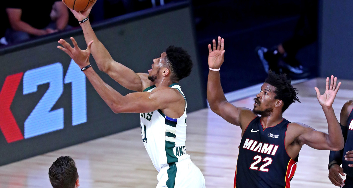 Milwaukee Bucks forward Giannis Antetokounmpo (34) shoots the ball against Miami Heat forward Jimmy Butler (22)