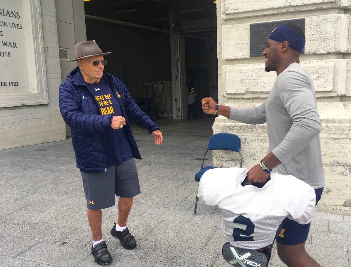 Bud "Dog" Turner greets a Cal player before practice
