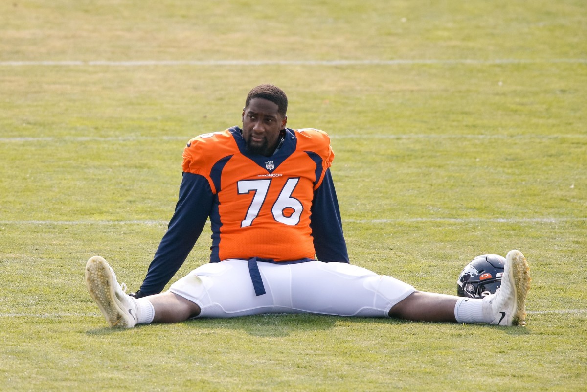 Denver Broncos offensive tackle Calvin Anderson (76) stretches during training camp at the UCHealth Training Center.