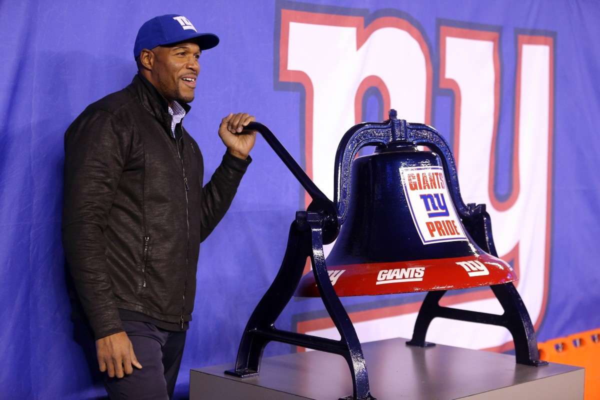 Nov 14, 2016; East Rutherford, NJ, USA; New York Giants former defensive end Michael Strahan rings a bell before a game between the New York Giants and the Cincinnati Bengals at MetLife Stadium.