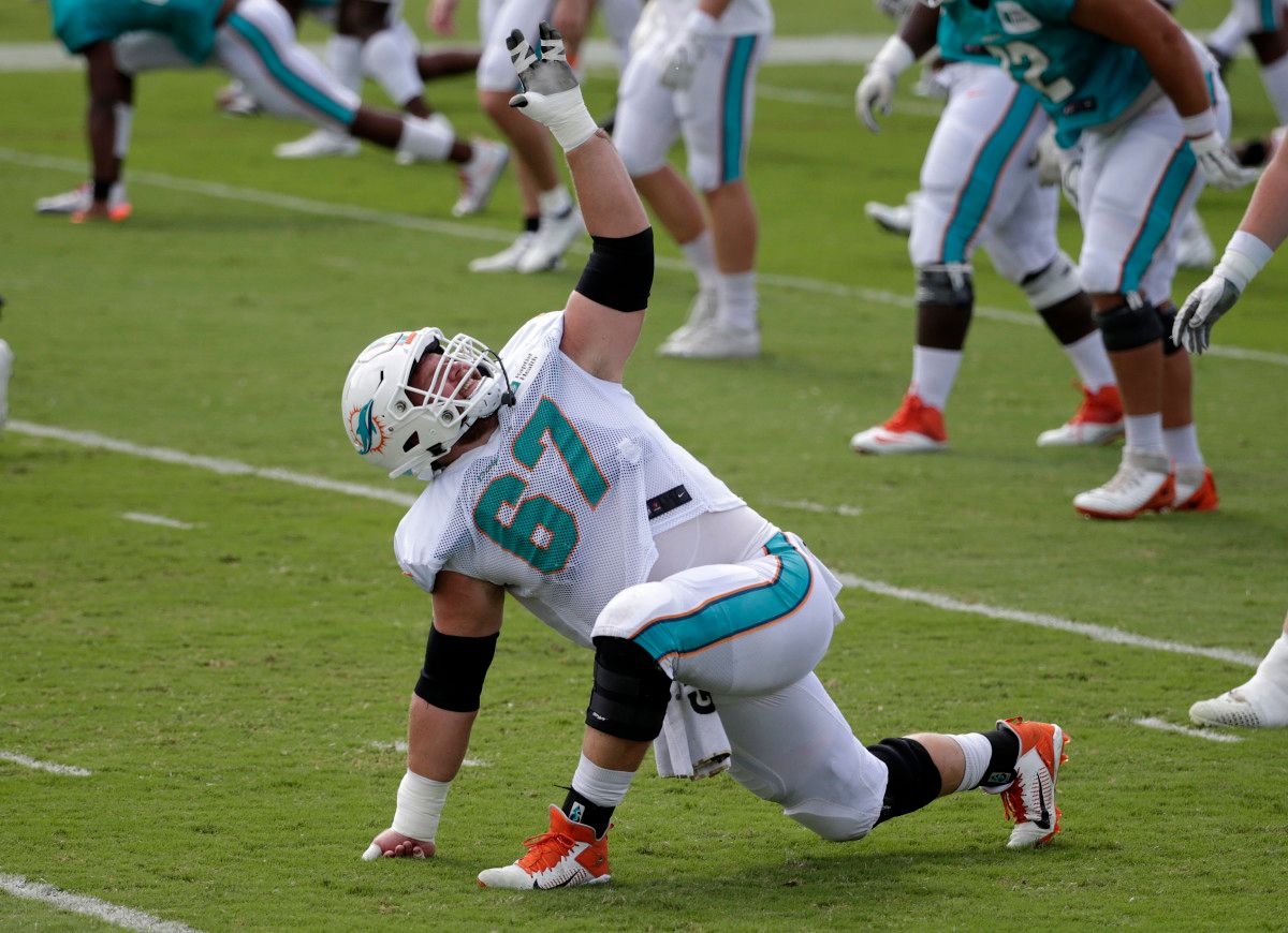 Miami Dolphins center Ted Karras (67) stretches during training camp at Baptist Health Training Facility.