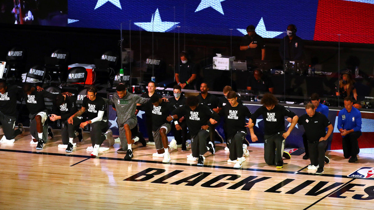 The Milwaukee Bucks kneeling on the court