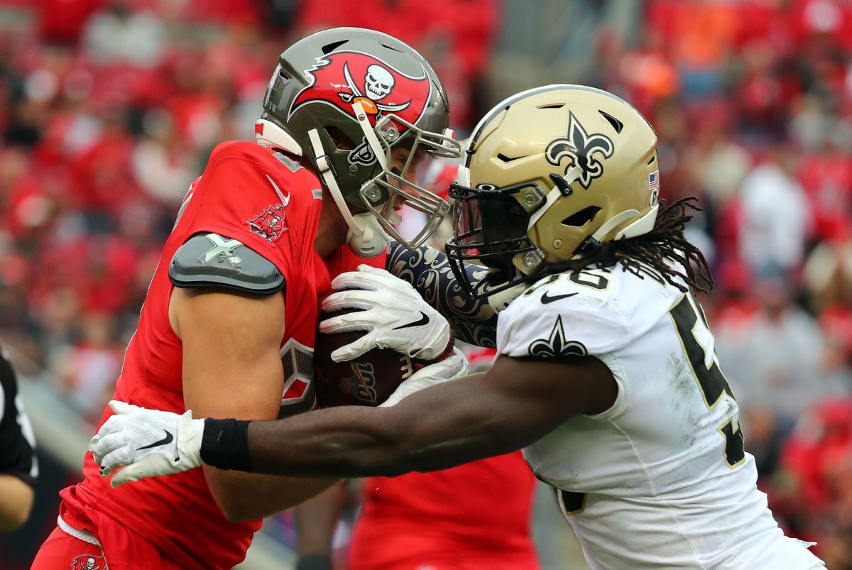 Nov 17, 2019; Tampa, FL, USA; New Orleans Saints outside linebacker Demario Davis (56) tackles Tampa Bay Buccaneers tight end Cameron Brate (84) during the second half at Raymond James Stadium. Mandatory Credit: Kim Klement-USA TODAY