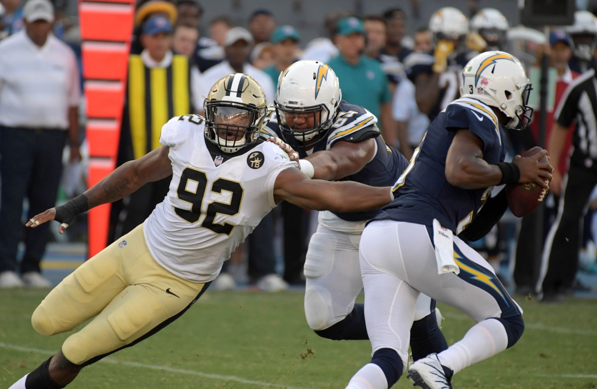 Aug 25, 2018; Carson, CA, USA; New Orleans Saints defensive end Marcus Davenport (92) pressures Los Angeles Chargers quarterback Geno Smith (3) as offensive tackle Cole Toner (64) defends during a preseason game at StubHub Center. The Saints defeated the Chargers 36-7. Mandatory Credit: Kirby Lee-USA TODAY