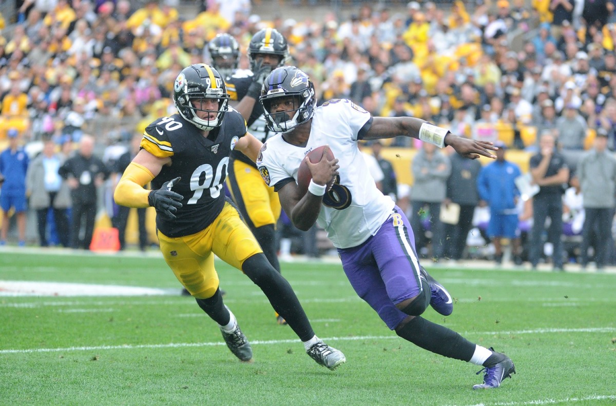Oct 6, 2019; Pittsburgh, PA, USA; Baltimore Ravens quarterback Lamar Jackson (8) runs from Pittsburgh Steelers linebacker T.J. Watt (90) during the first quarter at Heinz Field. Mandatory Credit: Philip G. Pavely-USA TODAY