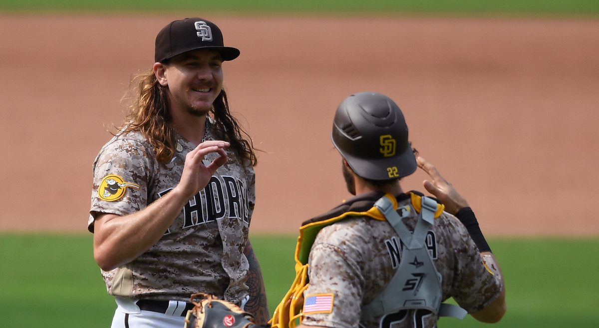 San Diego Padres starting pitcher Mike Clevinger (L) and catcher Austin Nola (22) celebrate after defeating the San Francisco Giants at Petco Park.
