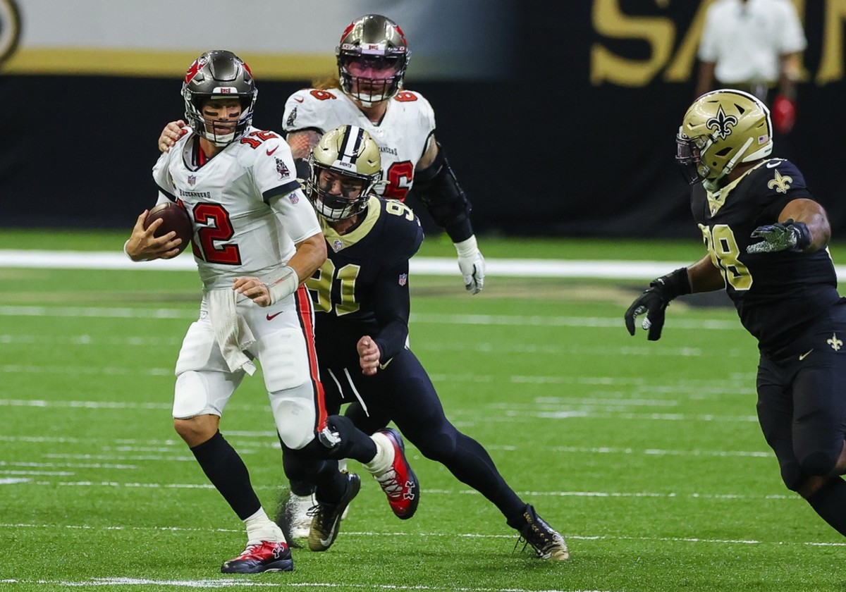 Sep 13, 2020; New Orleans, Louisiana, USA; Tampa Bay Buccaneers quarterback Tom Brady (12) is tackled by New Orleans Saints defensive end Trey Hendrickson (91) during the fourth quarter at the Mercedes-Benz Superdome. Mandatory Credit: Derick E. Hingle-USA TODAY