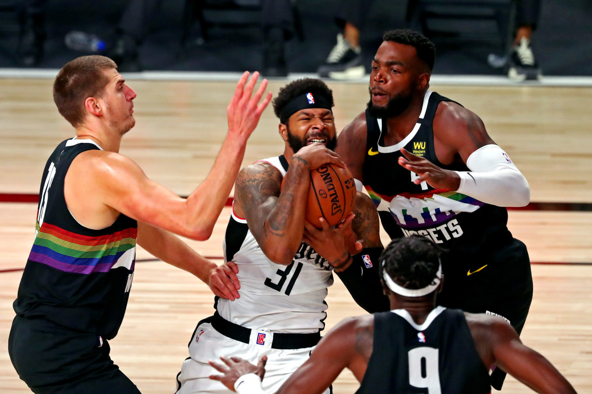LA Clippers forward Marcus Morris Sr. (31) drives to the basket against Denver Nuggets forward Paul Millsap (4) during the first quarter in game six of the second round of the 2020 NBA Playoffs