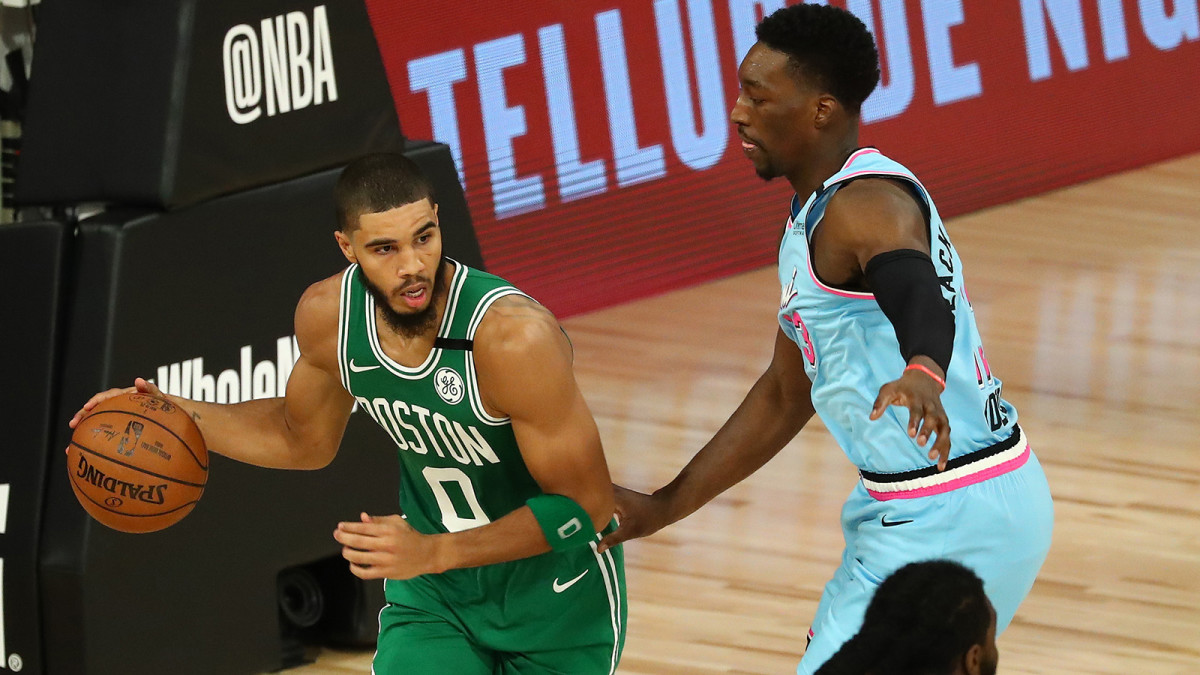 Boston Celtics forward Jayson Tatum controls the ball against Miami Heat forward Bam Adebayo in the second half of a NBA basketball game