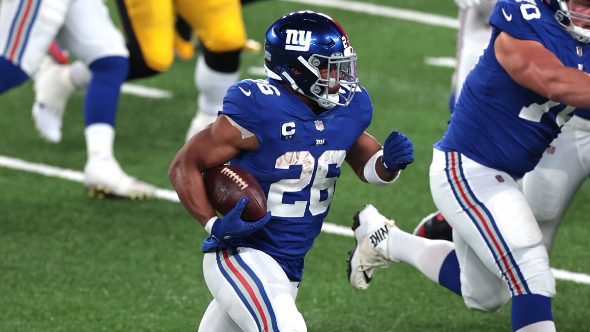 New York Giants running back Saquon Barkley (26) carries the ball against the Pittsburgh Steelers as offensive guard Kevin Zeitler (70) blocks during the second half at MetLife Stadium.