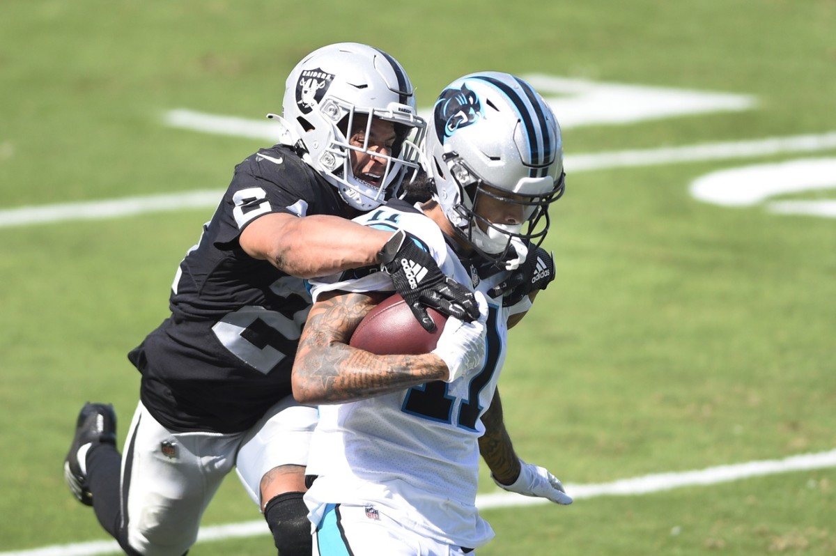 Sep 13, 2020; Charlotte, North Carolina, USA; Carolina Panthers wide receiver Robby Anderson (11) scores a touchdown as Las Vegas Raiders safety Johnathan Abram (24) defends in the fourth quarter at Bank of America Stadium. Mandatory Credit: Bob Donnan-USA TODAY Sports