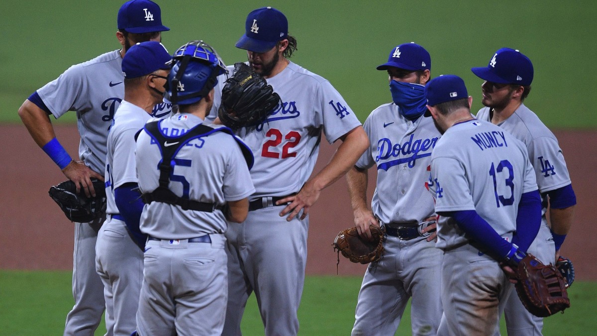 Los Angeles Dodgers manager Dave Roberts (second from left) talks to starting pitcher Clayton Kershaw (22) before replacing Kershaw during the seventh inning against the San Diego Padres at Petco Park.