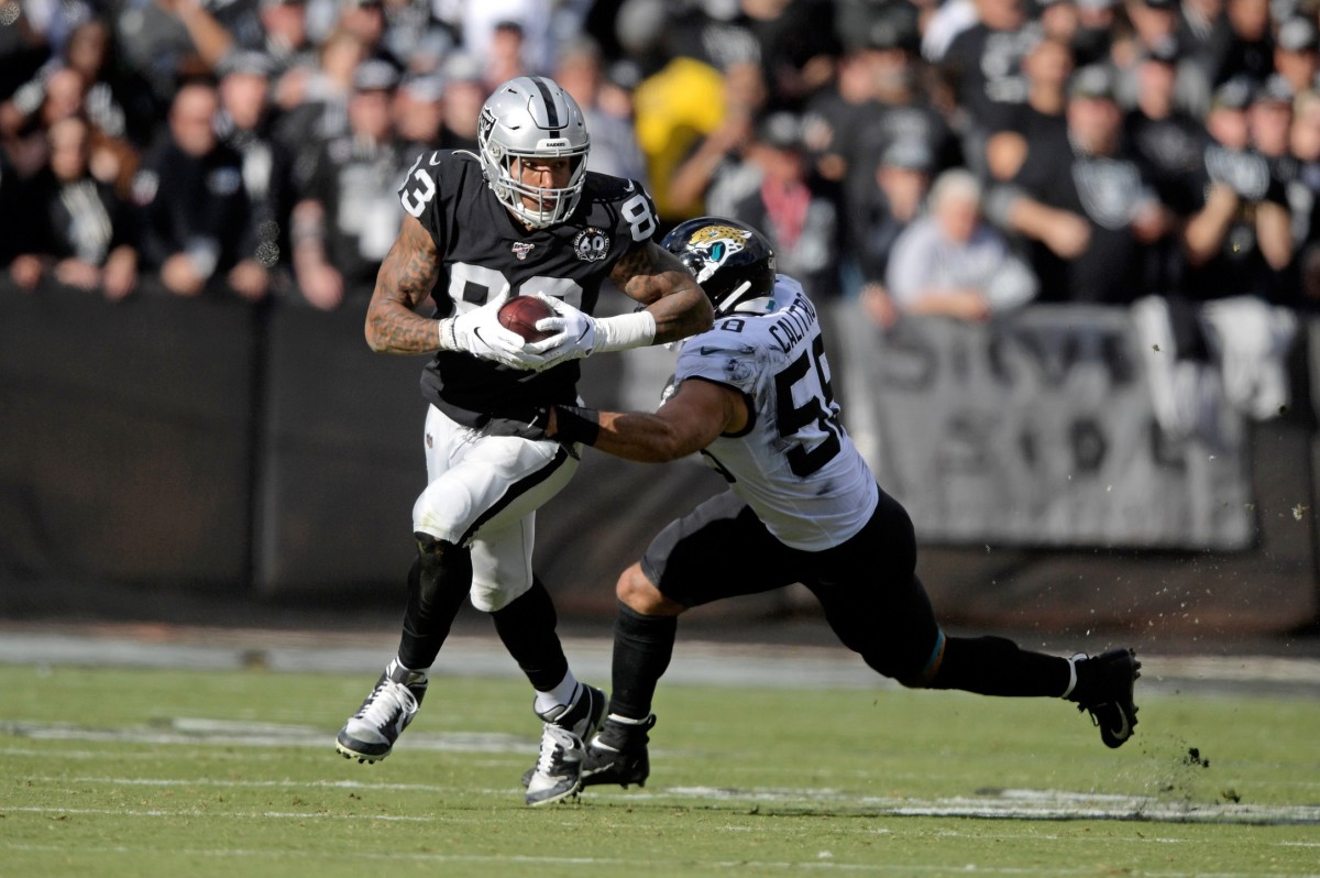 Dec 15, 2019; Oakland, CA, USA; Oakland Raiders tight end Darren Waller (83) carries the ball as Jacksonville Jaguars outside linebacker Austin Calitro (58) makes the tackle during the Raiders final game at the Oakland-Alameda Coliseum before relocating to Las Vegas for the 2020 season. Mandatory Credit: Kirby Lee-USA TODAY