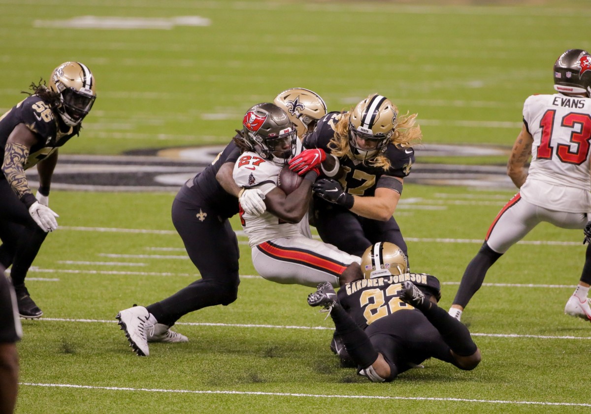 Sep 13, 2020; New Orleans, Louisiana, USA; New Orleans Saints defensive end Cameron Jordan (94) and linebacker Alex Anzalone (47) and safety C.J. Gardner-Johnson (22) tackle Tampa Bay Buccaneers running back Ronald Jones II (27) during the second half at the Mercedes-Benz Superdome. Mandatory Credit: Derick E. Hingle-USA TODAY