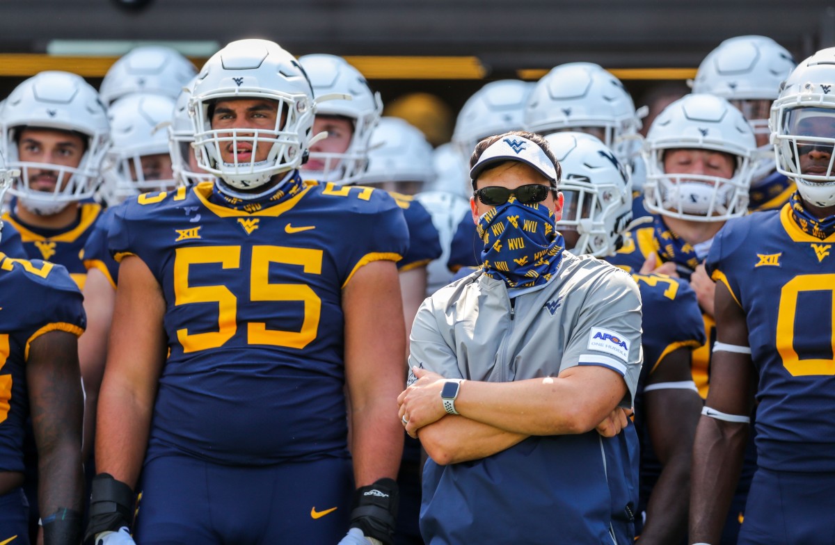 West Virginia Mountaineers head coach Neal Brown leads his team onto the field prior to their game against the Eastern Kentucky Colonels at Mountaineer Field at Milan Puskar Stadium.