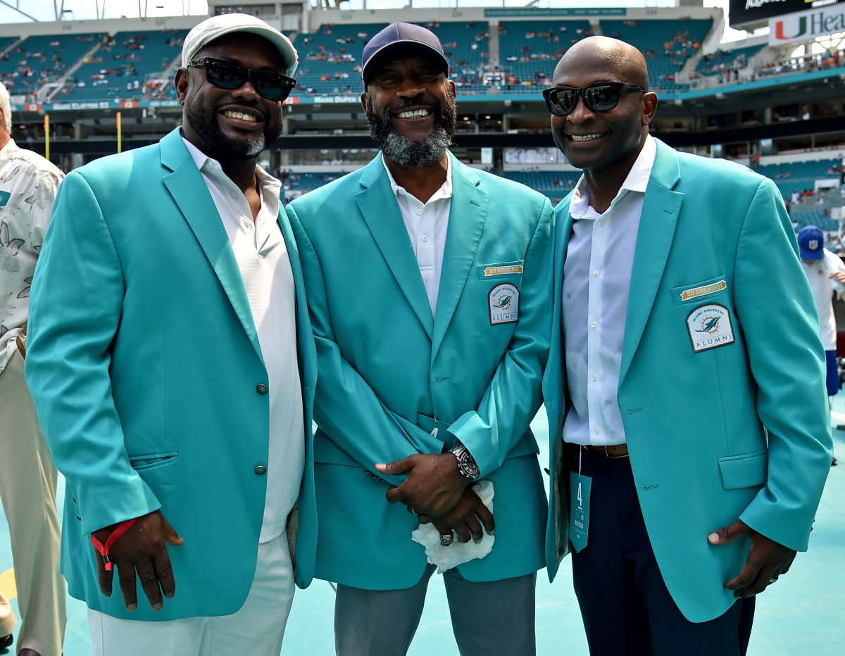 Former Dolphins running back Tony Nathan (center) stands with former wide receivers Mark Duper (left) and O.J. McDuffie (right) prior to a 2018 game against the Raiders at Hard Rock Stadium.