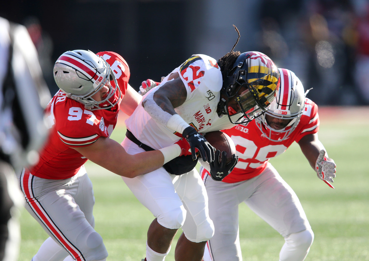 Noah Potter (97) makes a tackle, with help, against Maryland in 2019.