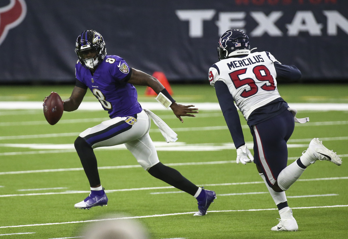Baltimore Ravens quarterback Lamar Jackson (8) rolls out of the pocket with the ball as Houston Texans outside linebacker Whitney Mercilus (59) applies defensive pressure during the second quarter at NRG Stadium.