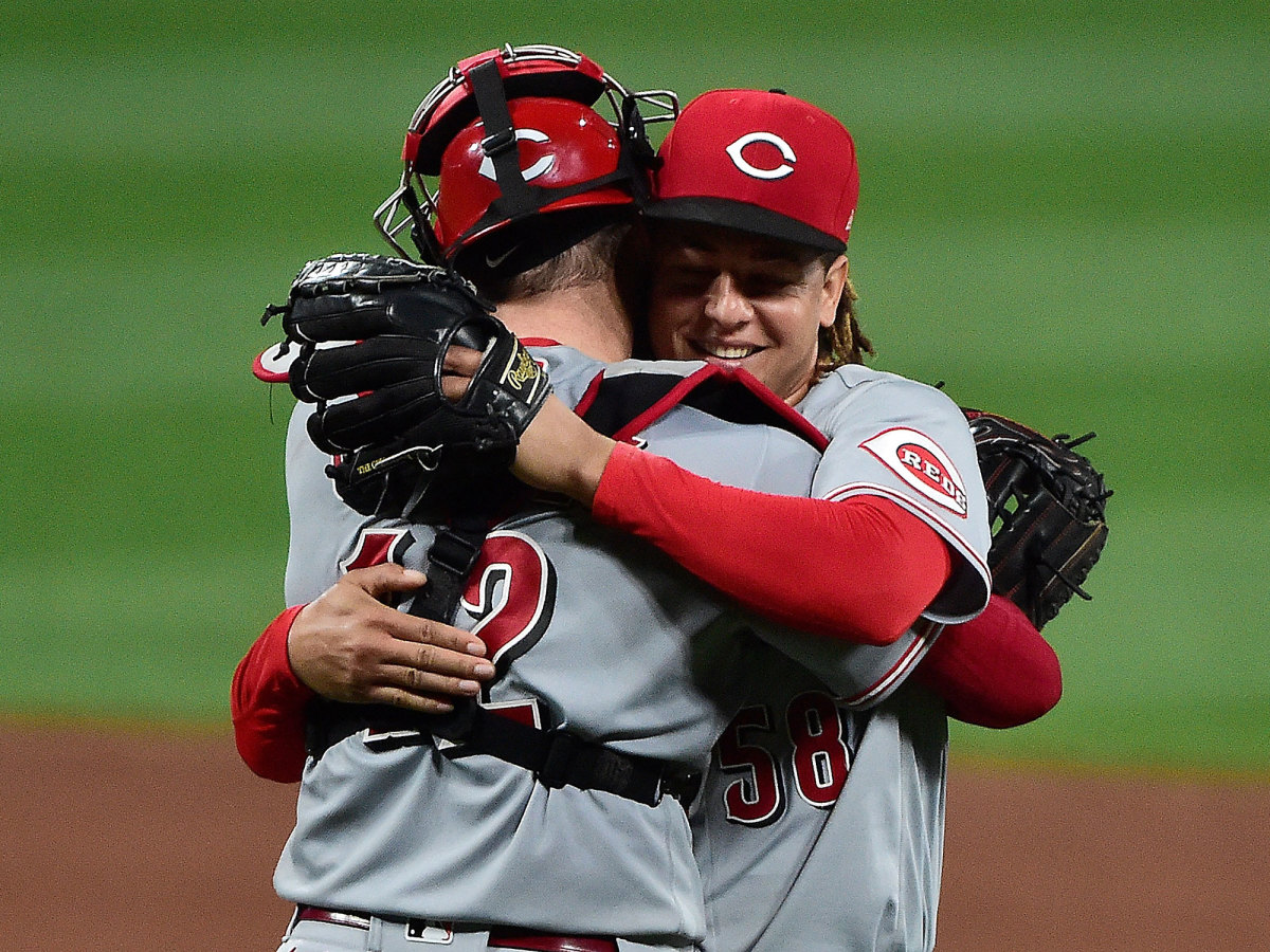 Luis Castillo hugs his catcher after a Reds win