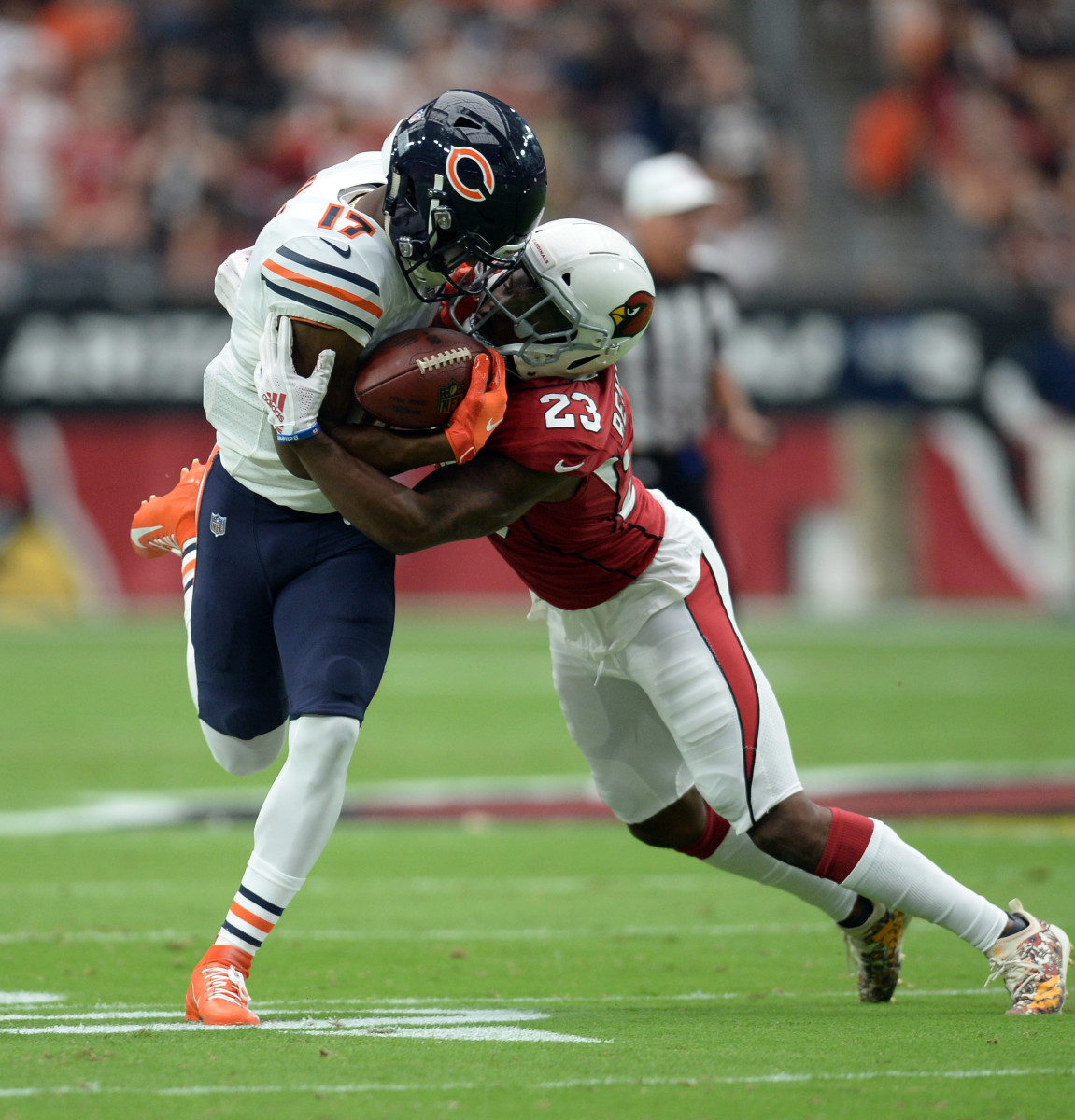 Cardinals defensive back Bene' Benwikere (23) tackles Bears wide receiver Anthony Miller (17) during a 2018 game. 