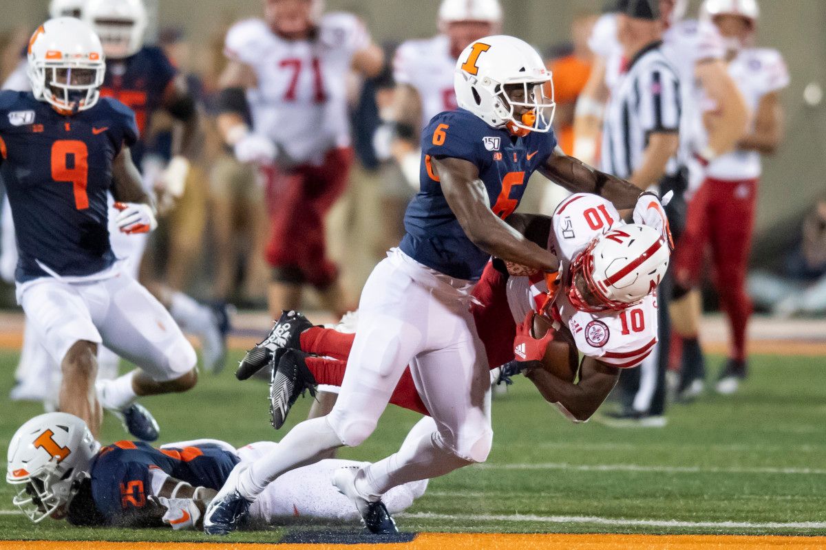 Illinois Fighting Illini defensive back Tony Adams (6) tackles Nebraska Cornhuskers wide receiver JD Spielman (10) during the first half at Memorial Stadium.