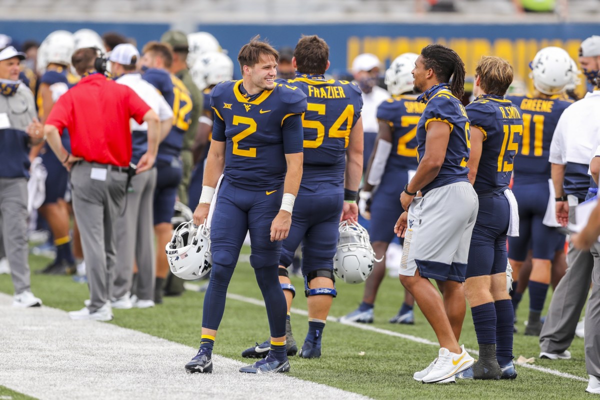 West Virginia Mountaineers quarterback Jarret Doege (2) talks along the sidelines with wide receiver Isaiah Esdale (9) during the fourth quarter against the Eastern Kentucky Colonels at Mountaineer Field