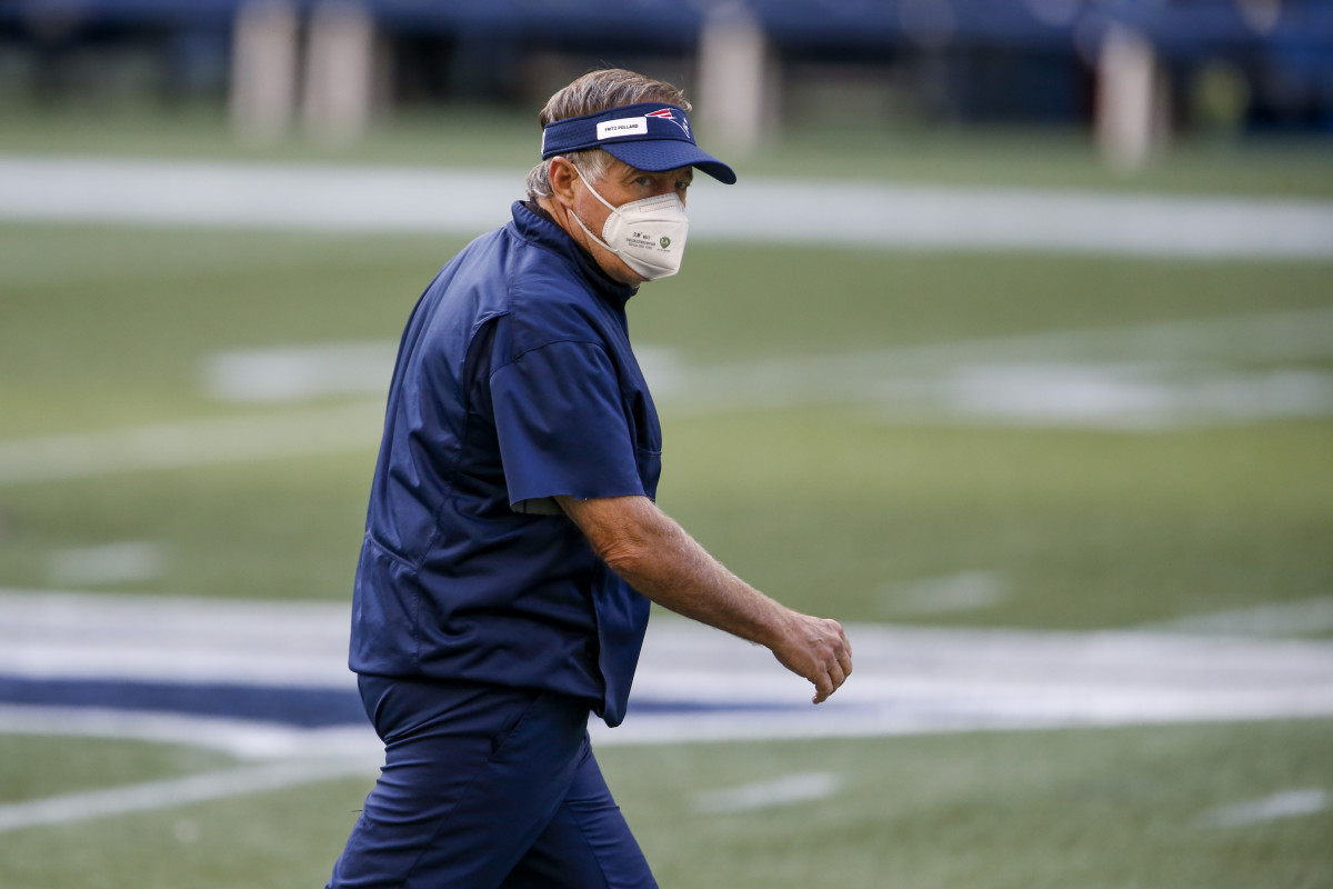 Patriots head coach Bill Belichick stares down CenturyLink Field wearing an N-95 face mask. 