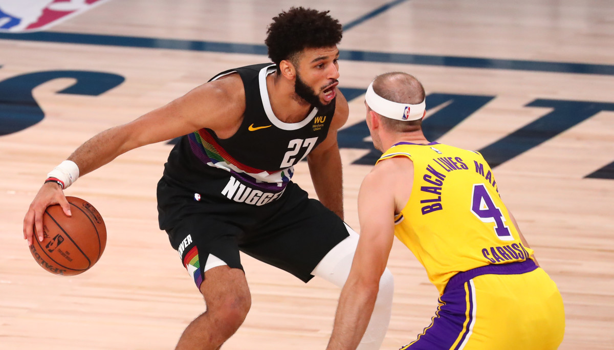 Denver Nuggets guard Jamal Murray (27) dribbles the ball around Los Angeles Lakers guard Alex Caruso (4) during the second half in game four of the Western Conference Finals of the 2020 NBA Playoffs