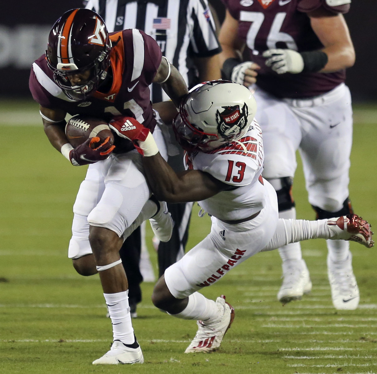 Tyler Baker-Williams makes a tackle on Virginia Tech's Tre Turner